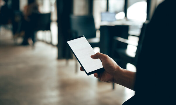 Focus On Hand Asian Businessman In Cafe Using Mobile Phone  Working And Find Information About Investments And Trading Stocks, Crypto, Dark Background