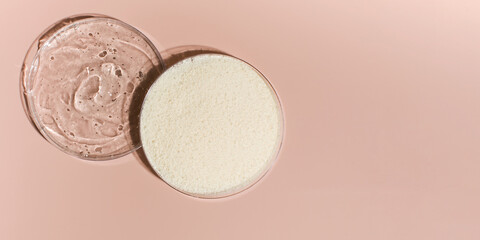 Samples of collagen powder and hyaluronic acid in Petri dishes on a pink background close-up view...