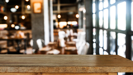 Empty dark wooden table in front of abstract blurred bokeh background of restaurant . can be used for display or montage your products.