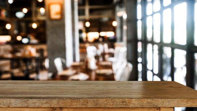 Empty dark wooden table in front of abstract blurred bokeh background of restaurant . can be used for display or montage your products.