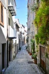 A narrow street between the old houses of Guardia Sanframondi, a village in the province of Benevento, Italy.	

