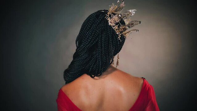 fantasy portrait happy african american woman princess smiling face. Girl queen golden crown on head, hairstyle braids. Red evening dress ball gown back rear view. Medieval fairy lady. Gray studio.