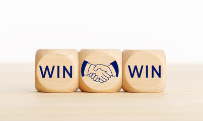 Win Win concept. Text and handshake Icon on wooden blocks. Copy space