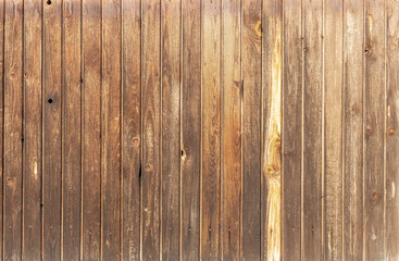 Wooden background. The old vertical brown picket boards are tight.
