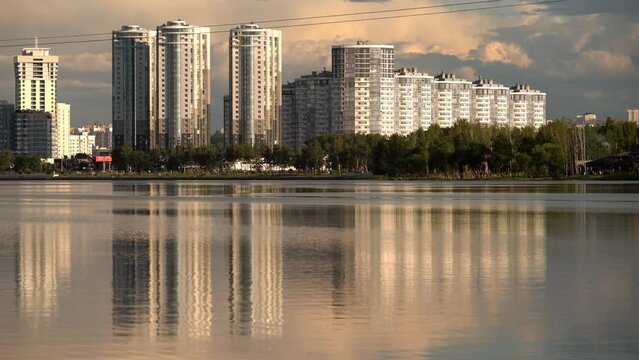 General view of the big city (Minsk), which is reflected in a large pond