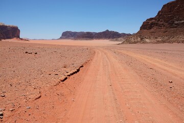 Dirty road on Wadi Rum desert in Jordan. Amazing Martian scenery of desert.
