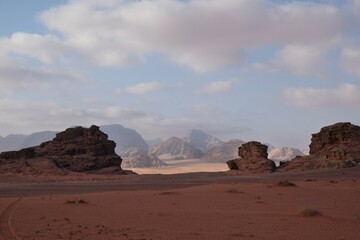 Fototapeta na wymiar Amazing scenery of Wadi Rum desert with red sand at sunrise. Desert looks like Mars.