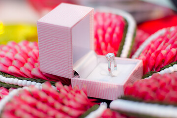 The wedding ring is placed in a decorative accessory.