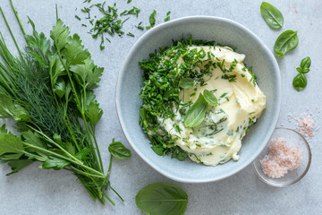 spicy herb butter on bowl and ingredients - 515798422