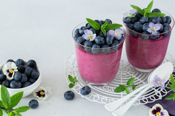 Blueberry trifle dessert in glass, decorated with fresh berries