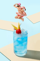 Collage with glass of tasty Blue Lagoon cocktail and funny jumping man with inflatable ring on color background