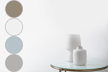 White vases on table near light wall. Different color patterns