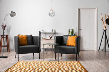 Black armchairs with coffee table in interior of modern living room © Pixel-Shot