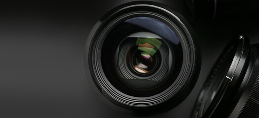 Lenses for photo camera on dark background, closeup