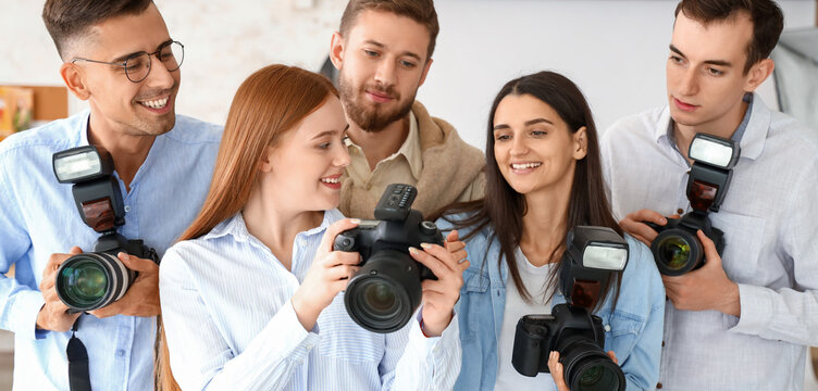 Professional photographer teaching young people in studio