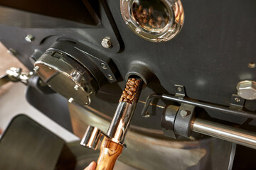 Coffee roast machine with roasted beans on factory