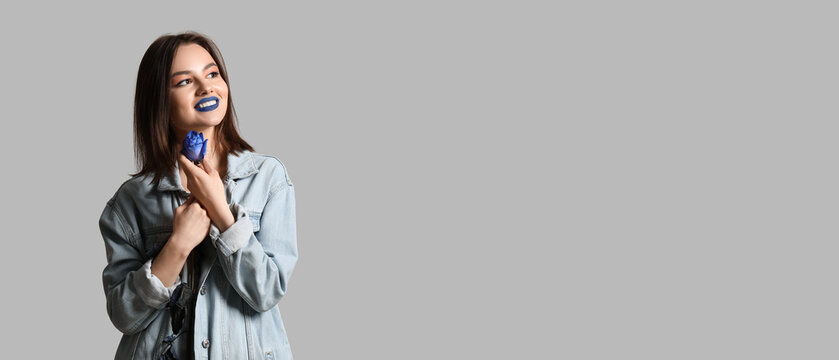 Stylish Young Woman With Blue Lipstick And Rose On Grey Background With Space For Text