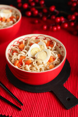 Bowls of tasty noodles with eggs on table