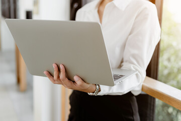 Close up business standing typing on laptop keyboard. Business surfing the internet.