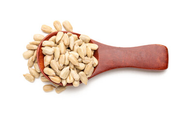Spoon with peeled sunflower seeds on white background