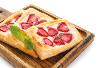 Board with strawberry puff pastries and mint leaves on white background