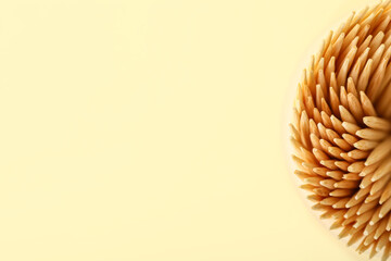 Wooden toothpicks  on color background, closeup