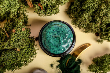 Jar of spirulina facial mask on color background