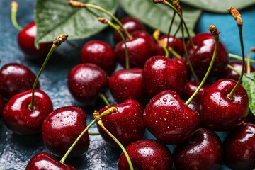 Ripe cherries with water drops on table, closeup