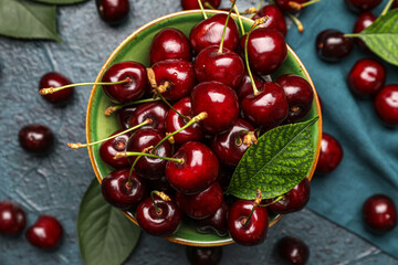 Bowl of ripe cherries on table, closeup