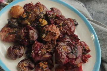 multicolored baked crushed potatoes close-up selective focus.