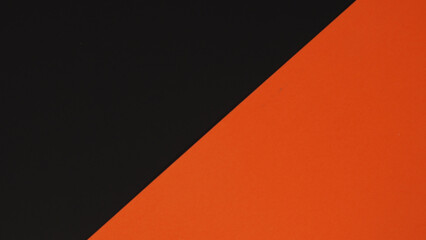 Orange and black paper board background. No people.