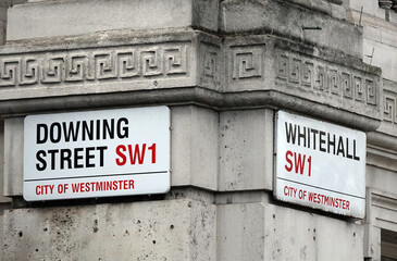 Street name signs at the junction of Downing Street and Whitehall in London, SW1. 