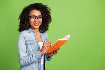 Profile side photo of young cheerful woman good mood write notes manager isolated over green color...