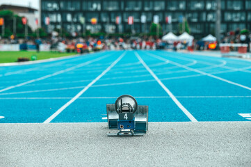 Track and Field race, illustrative photo. Starting blocks and the athletics stadium in the...