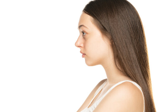 Profile portrait of serious teenage girl on a white background