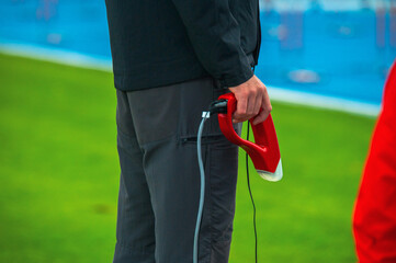 A starter holds a pistol before a start in an athletics race. Track and field, running photo