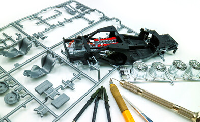 Top view of Assemble sports car plastic model for hobbyists , Hobby and leisure at home in quarantine.  Scale model of car,
