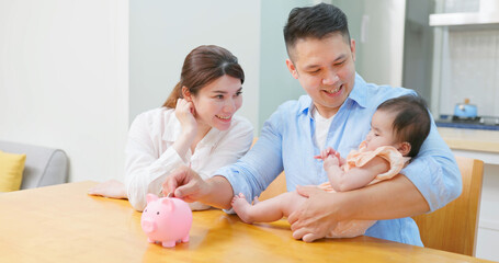 parents put coin in piggybank
