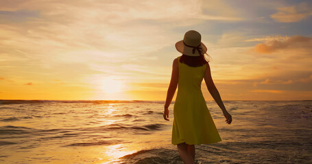 woman walking by beach