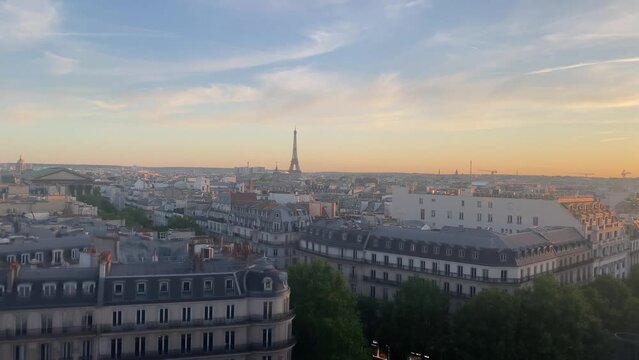 Paris city with Eiffel Tower at sunset, 2022
High altitude view over Paris rooftops and Eiffel tower, sunset, 2022
