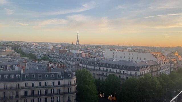 Paris city  rooftops with Eiffel Tower at sunset, 2022
High altitude view over Paris rooftops and Eiffel tower, sunset, 2022
