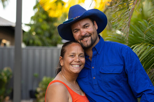 happy indigenous couple in their back yard.