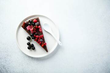Homemade raw chocolate cake with berries