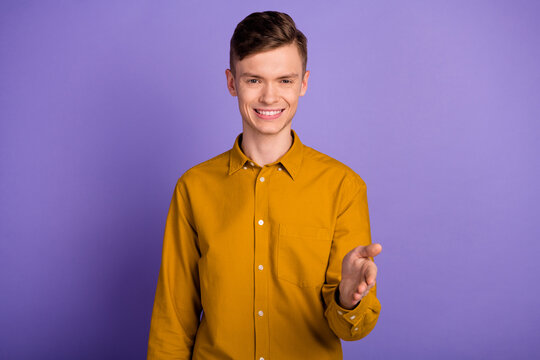 Photo of young handsome man intelligent handhsake meeting deal hello isolated over violet color background