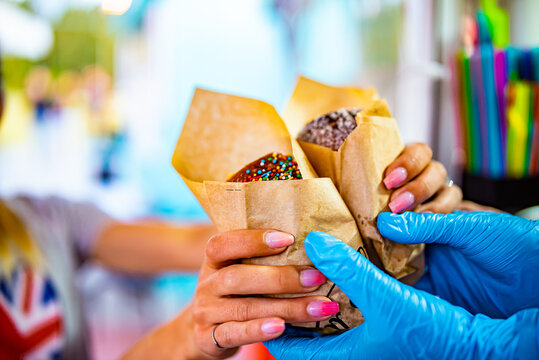 hand of chef baker making Trdlo or Trdelnik, Traditional tasty baked Czech Republic. street food