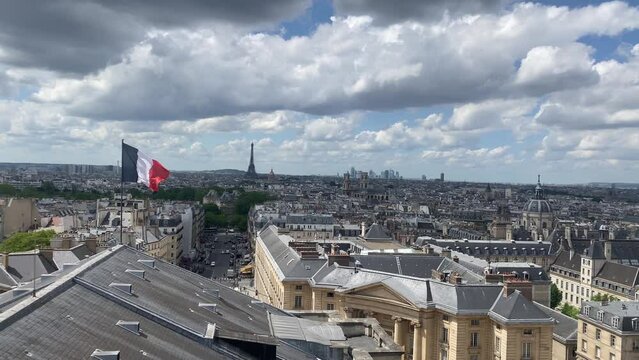 Paris City rooftops with France flag and Eiffel tower, high altitude
High altitude view over Paris rooftops, 2022
