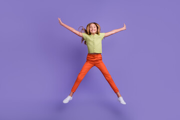 Fototapeta na wymiar Full body portrait of overjoyed energetic girl jumping make star figure isolated on purple color background
