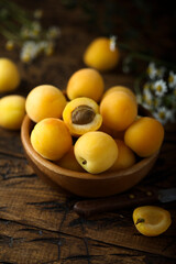 Fresh ripe apricots in a wooden bowl