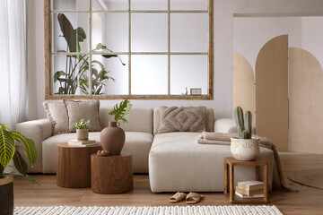 Living room interior design with modular beige sofa, wooden coffee tables, plants, textiles,...