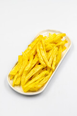 Fried potatoes. French fries isolated on white background. French fries served on a plate. close up